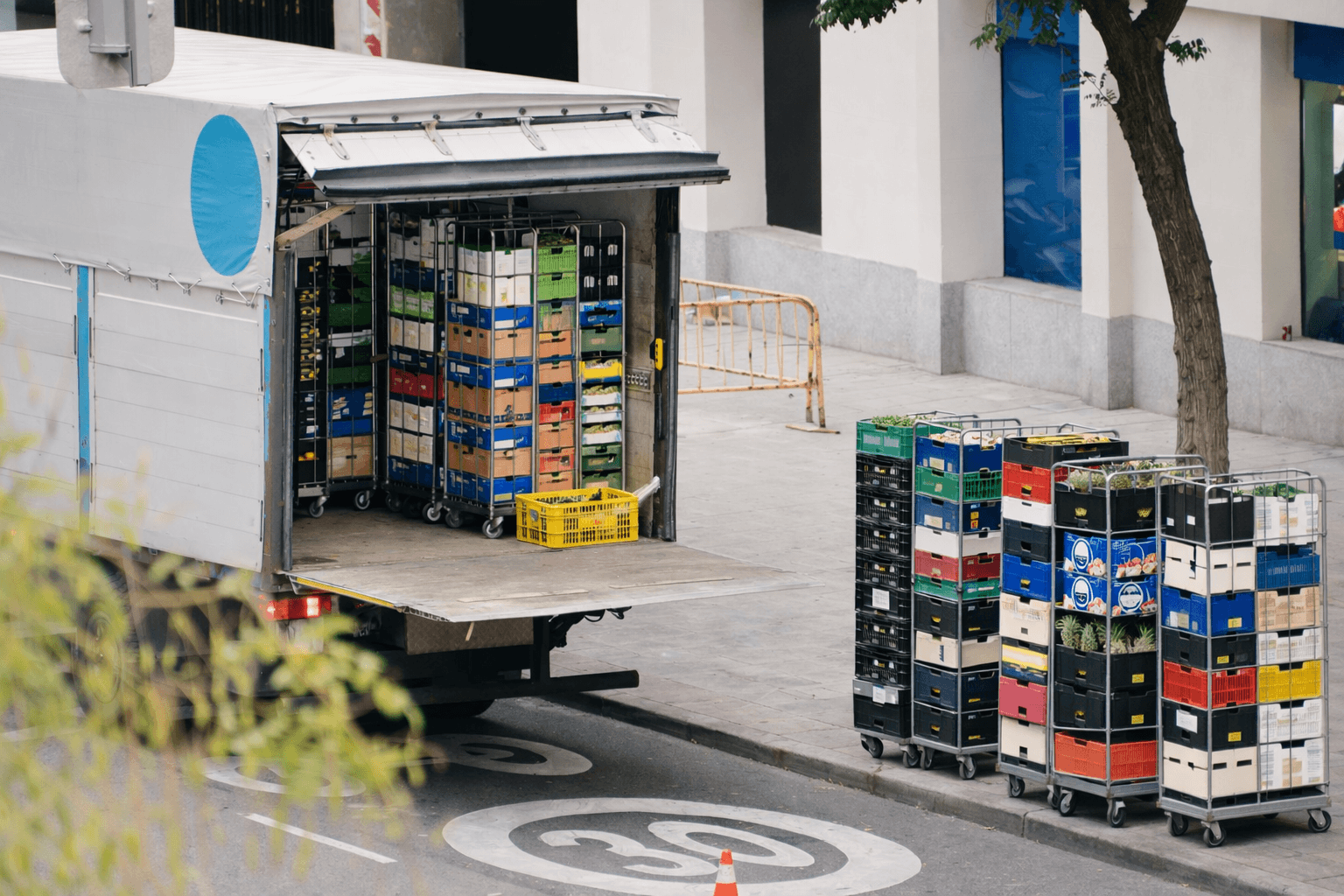 Delivery truck unloading food crates in urban setting